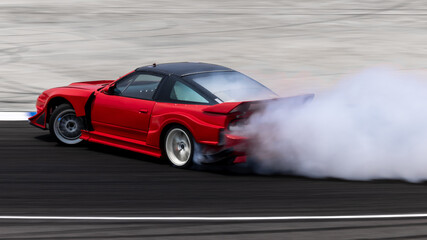 Car drifting on asphalt race track with lots of smoke from burning tires, Professional driver drift car on asphalt race track, Car motion blurred, Motorsport car drift. © Kalyakan