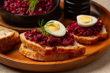 Beet or beetroot Caviar sandwich with boiled quail egg, bread and roasted vegetable toast.