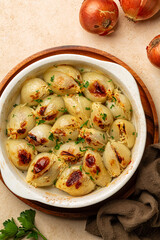 Oven baked Stuffed Onion. Stuffed onions with rice and meat. Traditional Greek or Turkish dishes, Salantourmasi or Sogan dolmasi. Top view, vertical image.