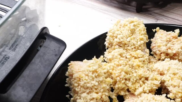 Using an air fryer to make homemade fish sticks for a quick and easy dinner,  Breaded fish sticks being cooked in an air fryer.  Easy seafood dinner meal.