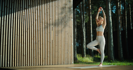 In the Heart of a Forest Retreat, a Female Yogi Moves Through Her Routine, Grounding Herself in Nature’s Calm. Soft Breeze and Fresh Air Enhance Meditation, Bringing Harmony to Her Practice