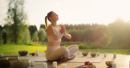 Portrait of a Female in Yoga Pose Focused on Meditating. Incense Candles Releasing Calming Scents...