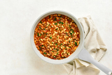 One pot meal with ground beef, pasta and vegetables simmered in tomato sauce