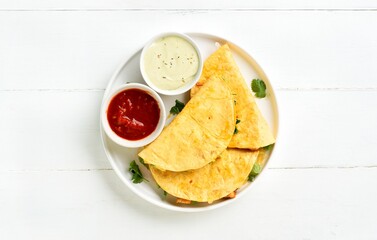 Quesadilla served with sauce, top view