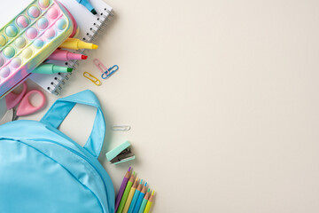 Organized school supplies including a blue backpack, stationery, and colorful items reflecting a back-to-school theme © ActionGP