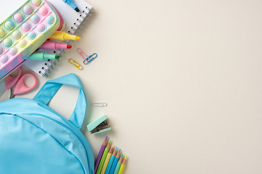 Organized school supplies including a blue backpack, stationery, and colorful items reflecting a back-to-school theme - Powered by Adobe