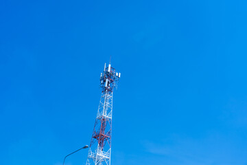 Signal towers against a blue sky in the afternoon