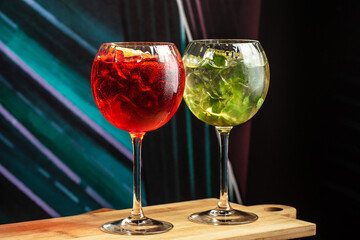 Cocktails assortment served on dark background. aperol spritz and mojito. menu concept