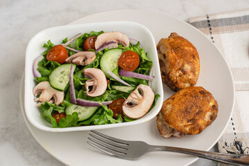 seasoned chicken thighs  with a garden salad