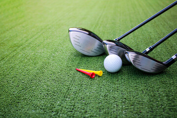 Close-up of Golf Clubs and Ball on Green Artificial Turf Surface