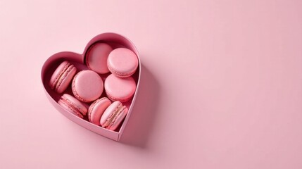 Fototapeta premium A heart-shaped box overflowing with delicate pink macarons, a delightful treat perfect for a romantic gesture or a sweet indulgence