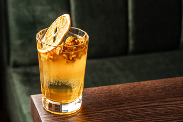 cocktail with popcorn decorated with a dried orange