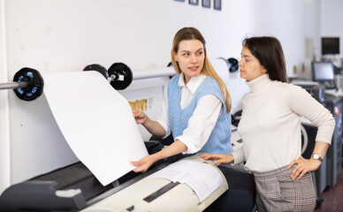Team of professionals works on printing equipment