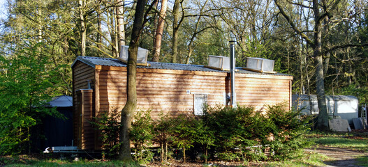 tiny house with rooftop boxes featuring skylights for energy generation