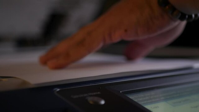 Close up office man using scanner panel the Office professional multi-function printer scanner for scanning document and printing. a Copy machines