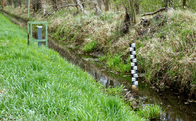 water level gauge and groundwater quality monitoring station at a drainage ditch on the edge of a...