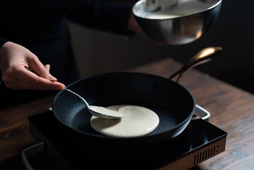 Cooking pancakes in pan on stove. Homemade breakfast.