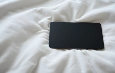 Blank black hotel keycard on a white bedsheet, black hotel keycard on bed for vacation
