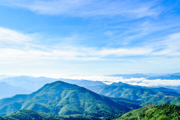 Fototapeta premium Scenic Mountain Landscape with Blue Sky and Layers of Misty Hills