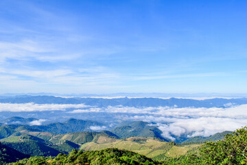 Fototapeta premium Scenic Mountain Landscape with Blue Sky and Layers of Misty Hills
