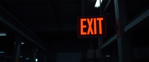 Illuminated Red Exit Sign Hanging in Dark Building Interior Emergency Exit Sign Safety Guidance