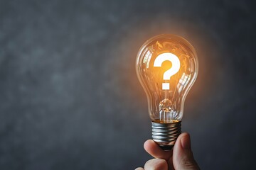 Illuminated Question A Hand Holds a Glowing Lightbulb with a Question Mark