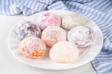 Various colorful fruit and berry mochi assortment. Traditional Japanese ice cream mochi, sweet dessert in rice dough, copy space