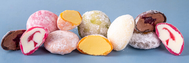 Various colorful fruit and berry mochi assortment. Traditional Japanese ice cream mochi, sweet dessert in rice dough, copy space