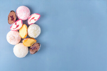 Various colorful fruit and berry mochi assortment. Traditional Japanese ice cream mochi, sweet dessert in rice dough, copy space