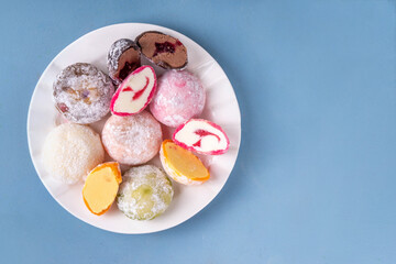 Various colorful fruit and berry mochi assortment. Traditional Japanese ice cream mochi, sweet dessert in rice dough, copy space