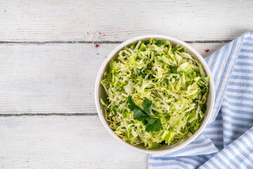 Spring cabbage salad, vegan healthy diet vegetable food, salad with spring cabbage, parsley, green onions, olive oil for dressing