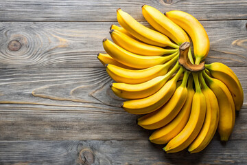 Fresh bananas all over. Season. Ripening. Harvest. Yellow background.