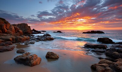 Sunset over the beach with colorful clouds. The sun reflects on the water, the waves crash