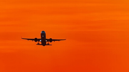Summer sunset or sundowner view with a jet airplane at Munich airport, MUC, Freising, Bavaria, Germany