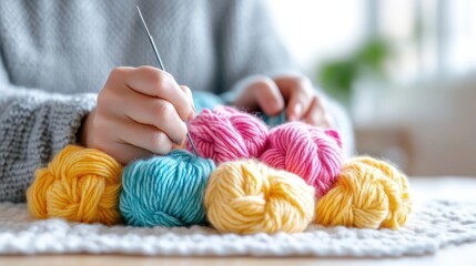 Hands carefully knitting with colorful yarn