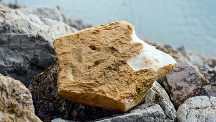 Garbage in the rocks on the seashore, close-up, pollution of nature, environmental problems, household waste, danger