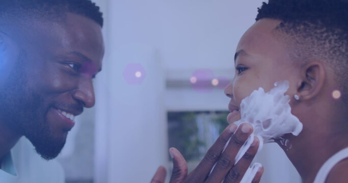 Image of lights over happy african american father and son shaving beards