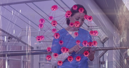 Image of network of connections with icons over smiling caucasian female doctor using tablet
