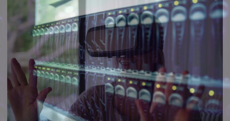 Image of women using vr headset over server room