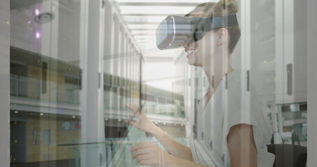 Image of women using vr headset over server room