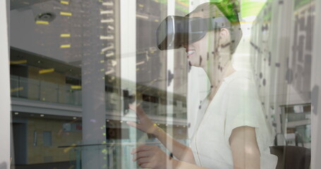 Image of women using vr headset over server room