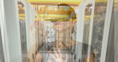 Image of women using vr headset over server room