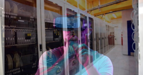 Image of men using vr headset over server room