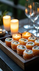A romantic sushi dinner setting, with salmon rolls, candles, and wine glasses beautifully lit.