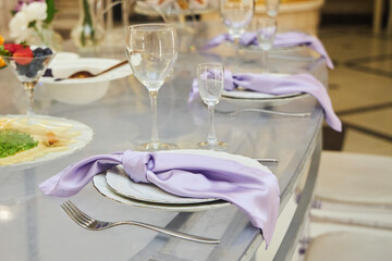 The decor of a festive table for a celebration. Glasses and plate