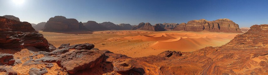 Naklejka premium Spectacular panorama of the wadi rum desert, showing the sand dunes and beautiful red rock formations.