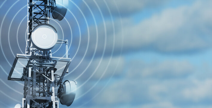 antenna tower as phone base station  with radio waves isolated on cloudy sky background, concept with copy space for wireless and mobile communication, tv and internet