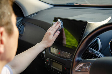 Cleaning Car Touchscreen with a Cloth for Better Visibility