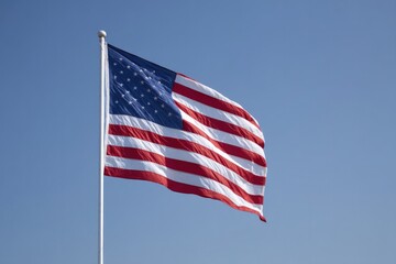 Obraz premium solitary american flag waving against clear blue sky provides stunning minimalistic image with ample copy space