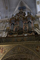 Seville, Spain - Mar 23, 2025: Walking in Seville. Real Parroquia de Santa Maria Magdalena. Streets, buildings. Lifestyle in the urban area. Cloudy spring day. Selective focus
